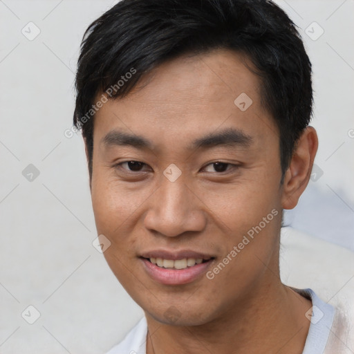 Joyful asian young-adult male with short  brown hair and brown eyes