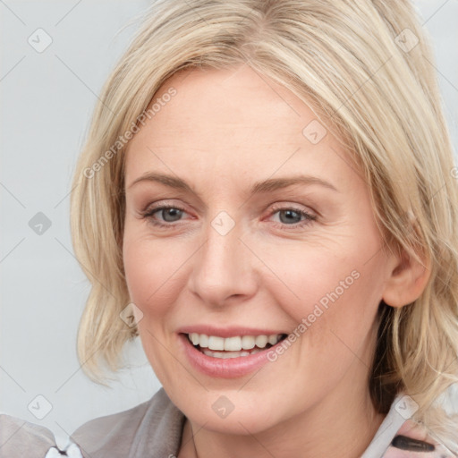 Joyful white young-adult female with medium  brown hair and blue eyes