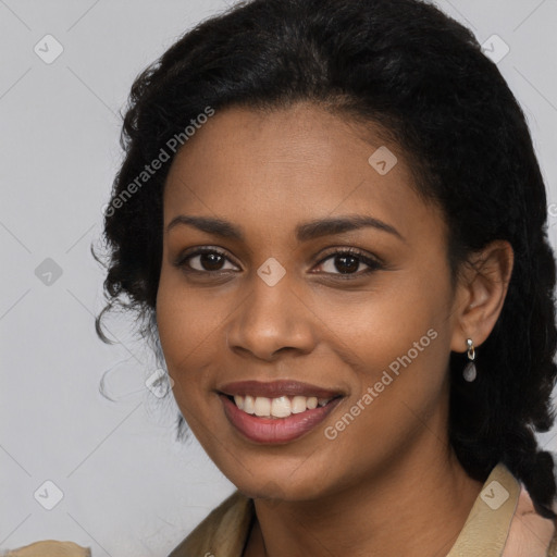 Joyful black young-adult female with long  black hair and brown eyes