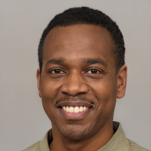 Joyful latino adult male with short  black hair and brown eyes