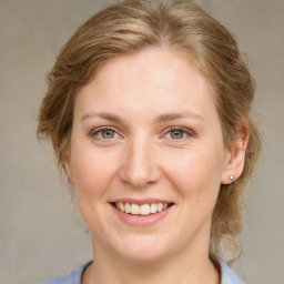 Joyful white young-adult female with medium  brown hair and blue eyes