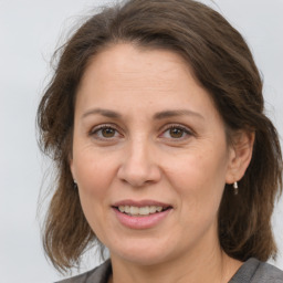 Joyful white adult female with medium  brown hair and brown eyes