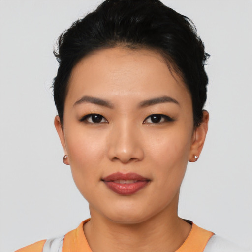 Joyful asian young-adult female with short  black hair and brown eyes