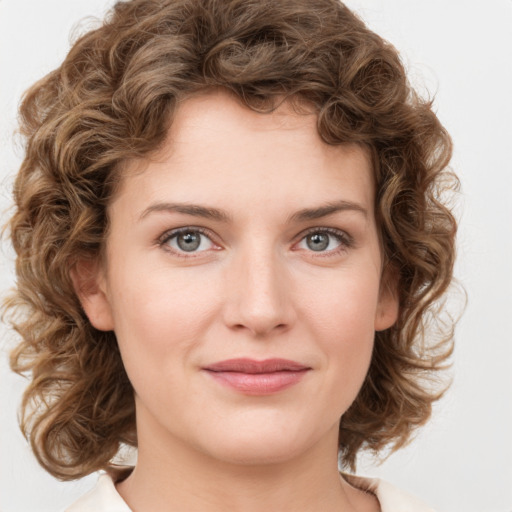 Joyful white young-adult female with medium  brown hair and green eyes