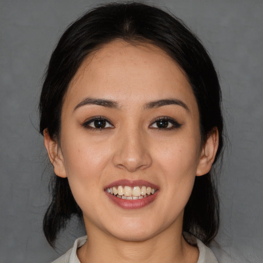 Joyful white young-adult female with medium  black hair and brown eyes