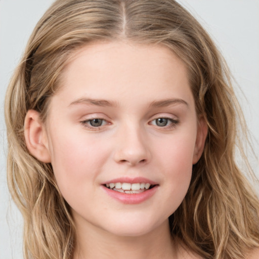 Joyful white child female with long  brown hair and blue eyes