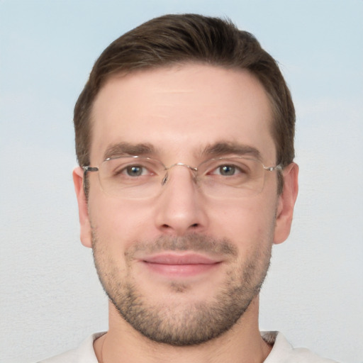 Joyful white young-adult male with short  brown hair and grey eyes