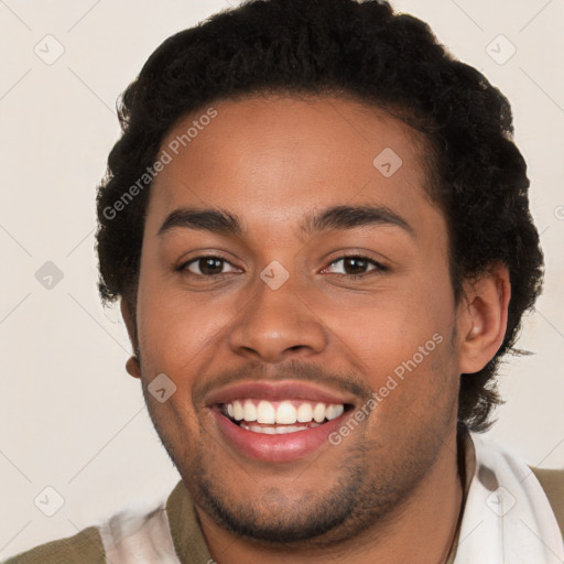 Joyful latino young-adult male with short  brown hair and brown eyes