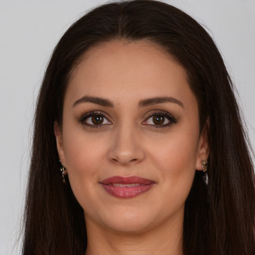 Joyful white young-adult female with long  brown hair and brown eyes