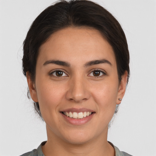 Joyful white young-adult female with medium  brown hair and brown eyes