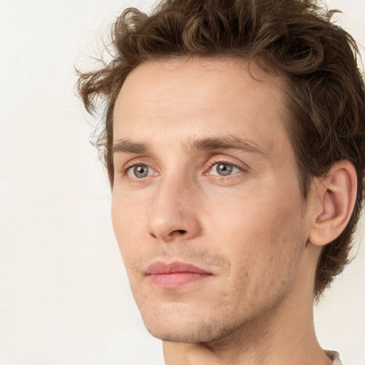 Joyful white young-adult male with short  brown hair and green eyes