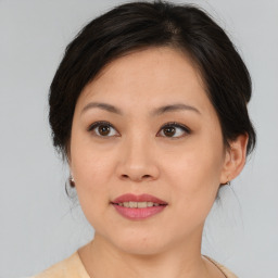 Joyful asian young-adult female with medium  brown hair and brown eyes