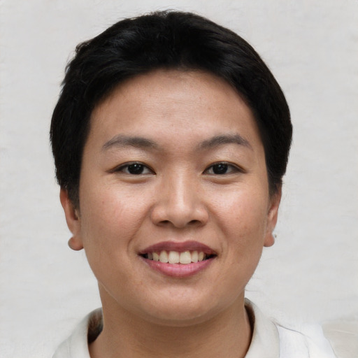 Joyful asian young-adult female with short  brown hair and brown eyes