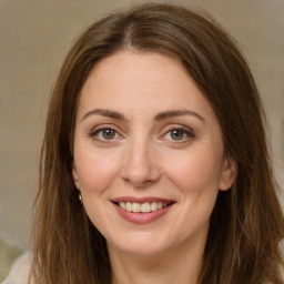 Joyful white adult female with long  brown hair and brown eyes