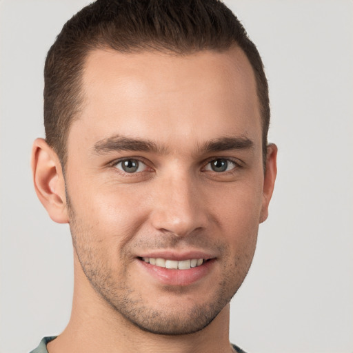 Joyful white young-adult male with short  brown hair and brown eyes