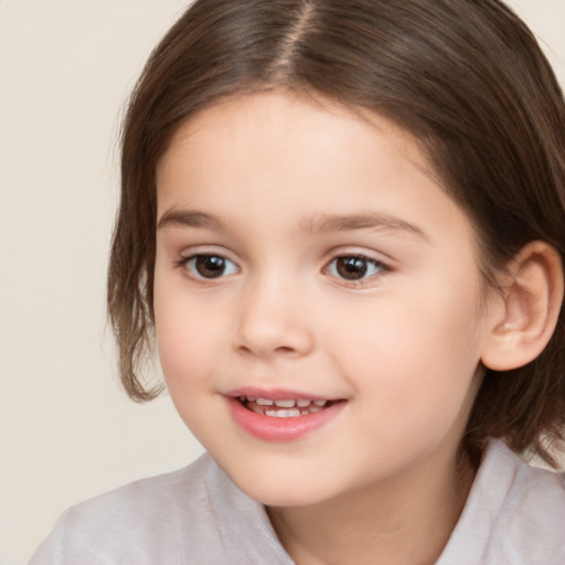 Joyful white child female with medium  brown hair and brown eyes