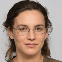 Joyful white adult female with medium  brown hair and grey eyes