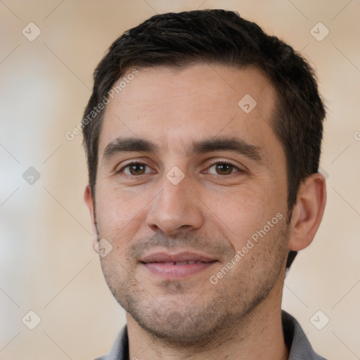 Joyful white young-adult male with short  black hair and brown eyes
