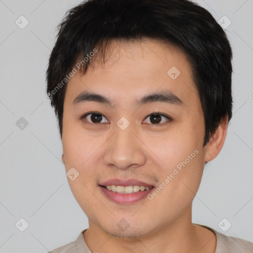 Joyful asian young-adult male with short  brown hair and brown eyes