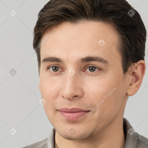 Joyful white young-adult male with short  brown hair and brown eyes