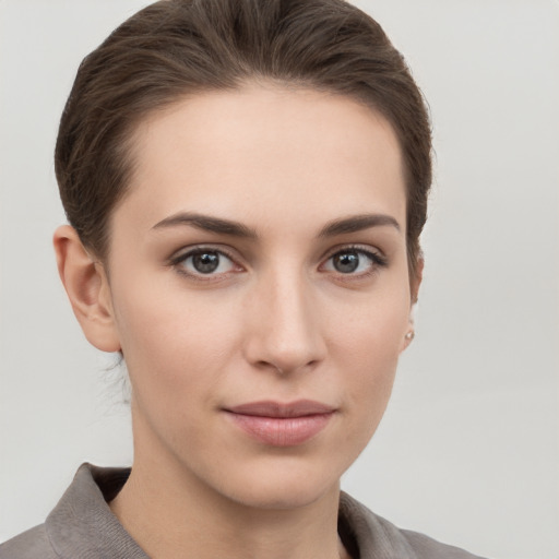 Joyful white young-adult female with short  brown hair and grey eyes