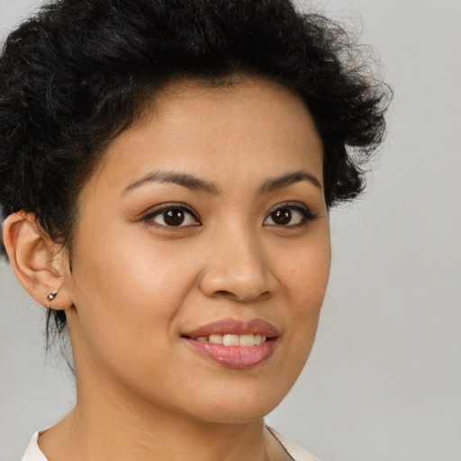 Joyful latino young-adult female with short  brown hair and brown eyes