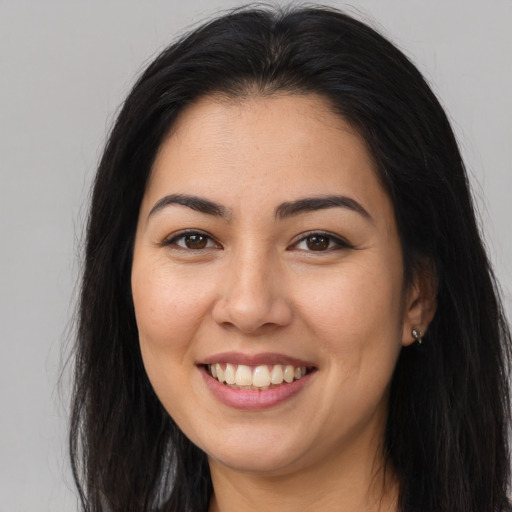 Joyful asian young-adult female with long  brown hair and brown eyes