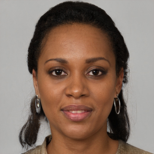 Joyful black young-adult female with medium  black hair and brown eyes