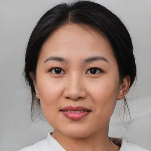 Joyful asian young-adult female with medium  brown hair and brown eyes
