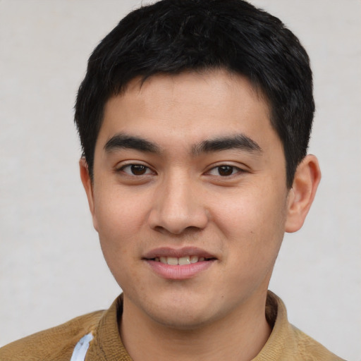 Joyful asian young-adult male with short  black hair and brown eyes