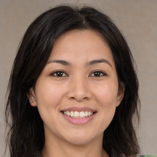 Joyful asian young-adult female with long  brown hair and brown eyes