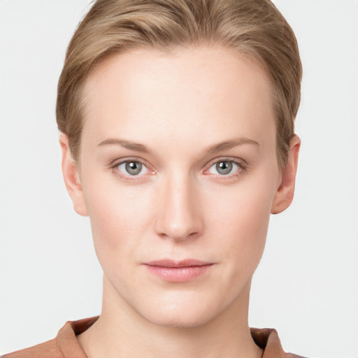 Joyful white young-adult female with short  brown hair and grey eyes