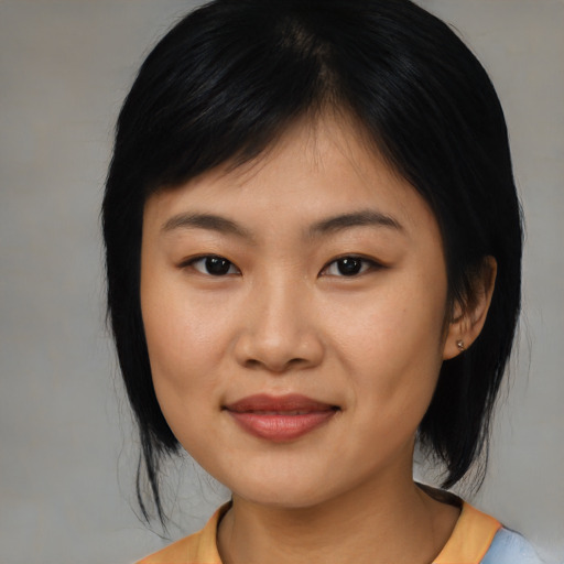 Joyful asian young-adult female with medium  black hair and brown eyes