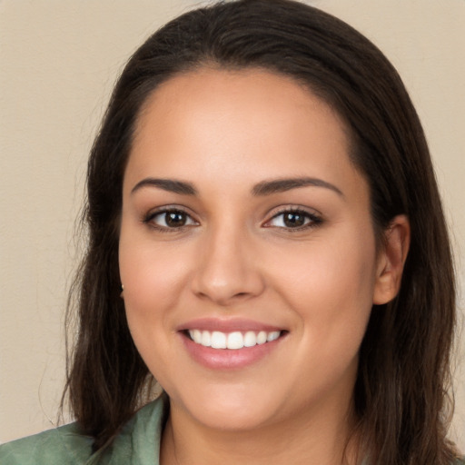 Joyful white young-adult female with long  brown hair and brown eyes