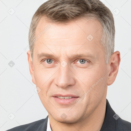 Joyful white adult male with short  brown hair and grey eyes