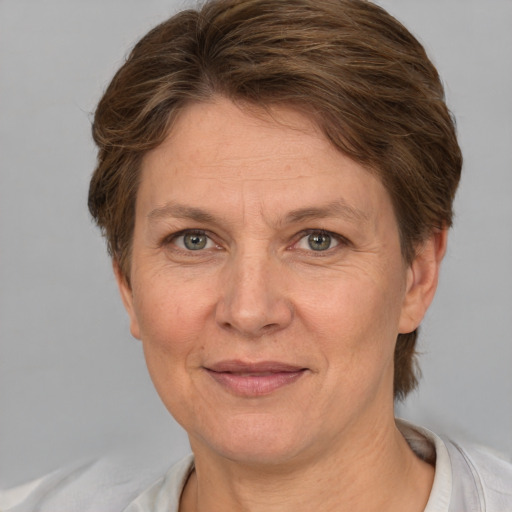 Joyful white adult female with short  brown hair and grey eyes