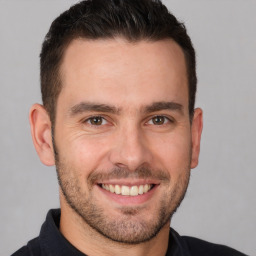 Joyful white young-adult male with short  brown hair and brown eyes