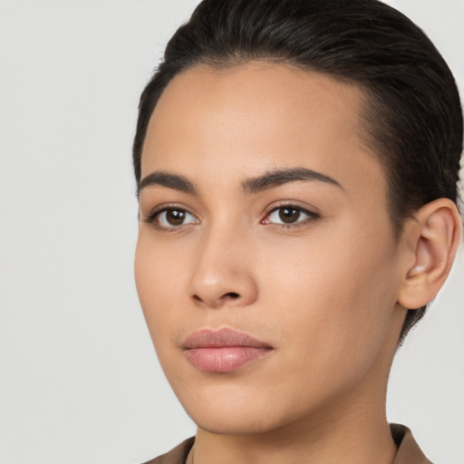 Joyful latino young-adult female with short  brown hair and brown eyes