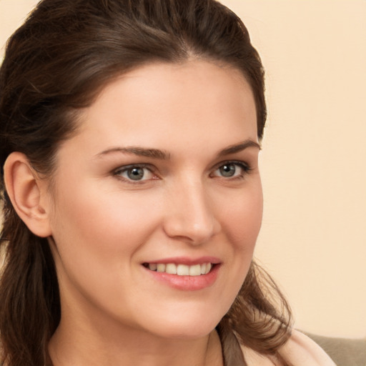 Joyful white young-adult female with long  brown hair and brown eyes