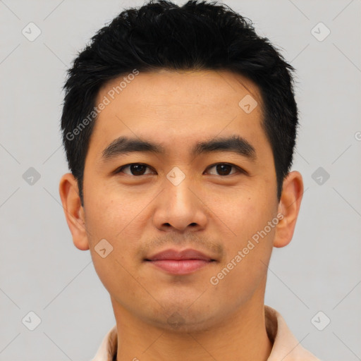 Joyful asian young-adult male with short  black hair and brown eyes