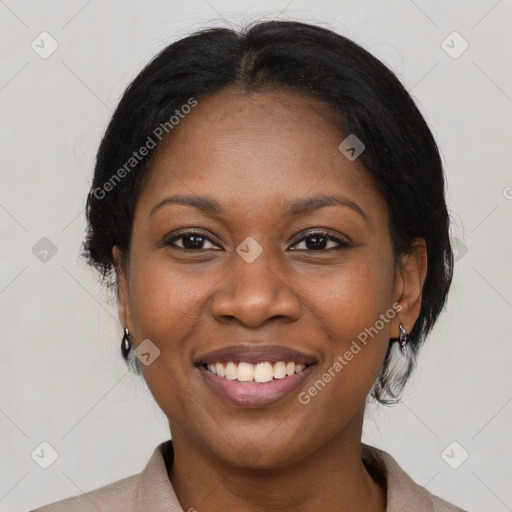 Joyful black adult female with medium  brown hair and brown eyes