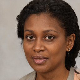 Joyful black adult female with medium  brown hair and brown eyes