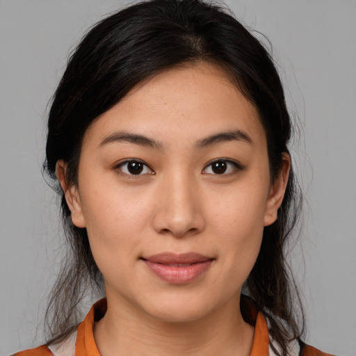 Joyful latino young-adult female with medium  brown hair and brown eyes