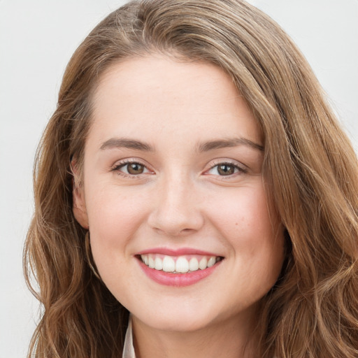 Joyful white young-adult female with long  brown hair and green eyes