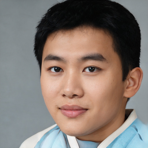 Joyful asian young-adult male with short  black hair and brown eyes