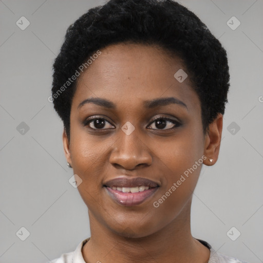 Joyful black young-adult female with short  black hair and brown eyes