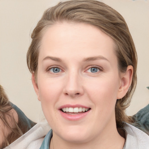 Joyful white young-adult female with medium  brown hair and blue eyes