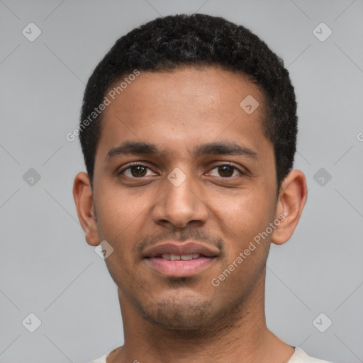 Joyful black young-adult male with short  black hair and brown eyes