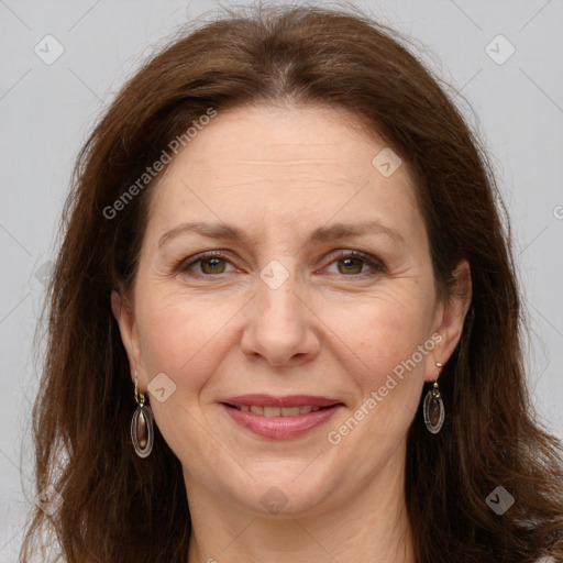 Joyful white adult female with long  brown hair and grey eyes