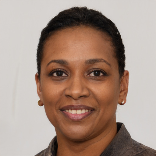 Joyful black young-adult female with short  black hair and brown eyes